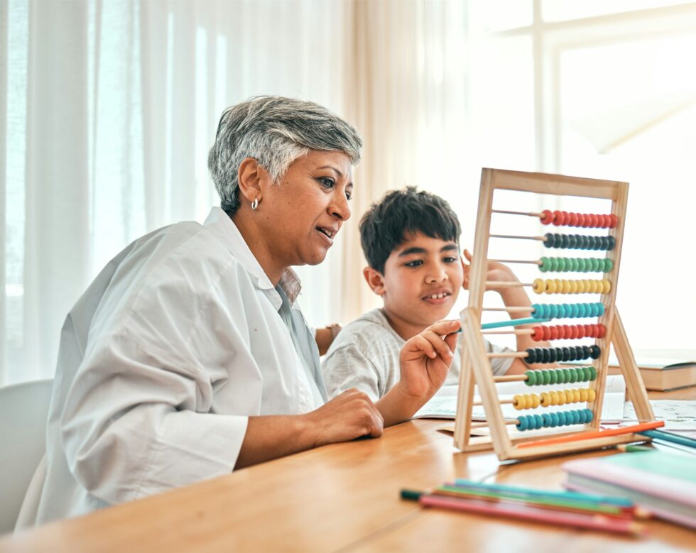 Education, autism and abacus with a grandmother teaching maths to her grandchild in the home for ch